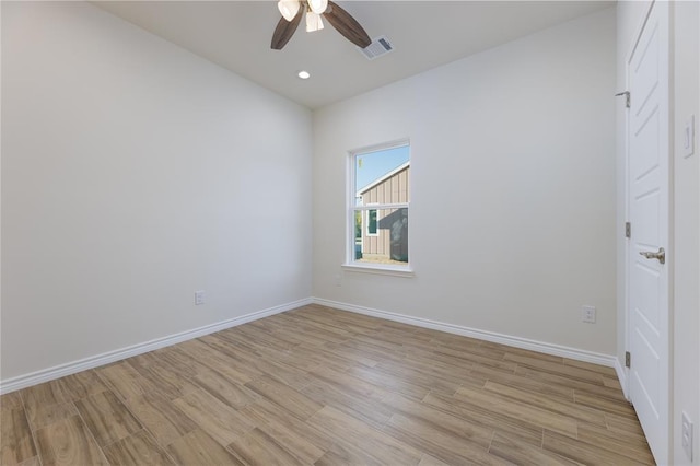 spare room with light hardwood / wood-style flooring and ceiling fan