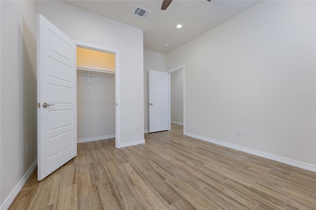 unfurnished bedroom with ceiling fan, light hardwood / wood-style floors, and a closet