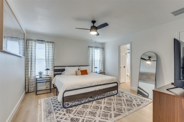 bedroom with ceiling fan and light hardwood / wood-style flooring