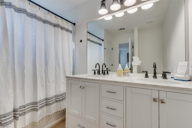 bathroom with a shower with curtain and vanity