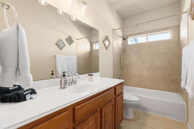 full bathroom featuring tile patterned flooring, vanity, tiled shower / bath combo, and toilet