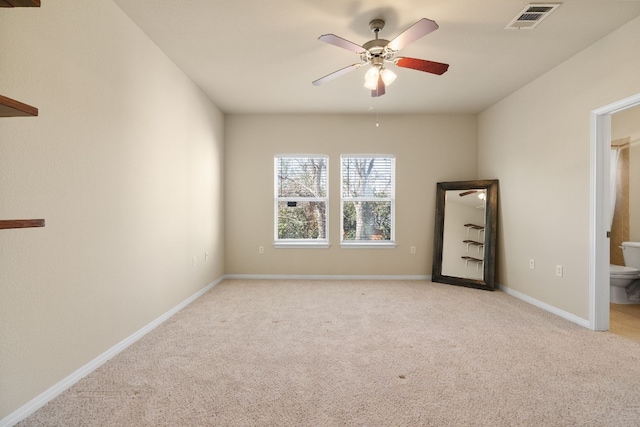 spare room with light carpet and ceiling fan