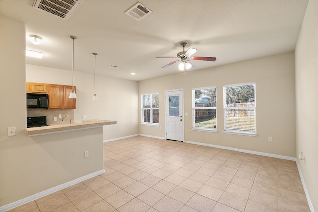 unfurnished living room with ceiling fan and light tile patterned floors