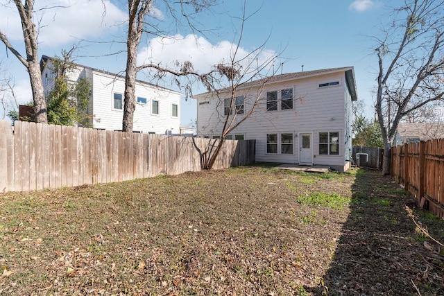 back of property with a yard and a patio