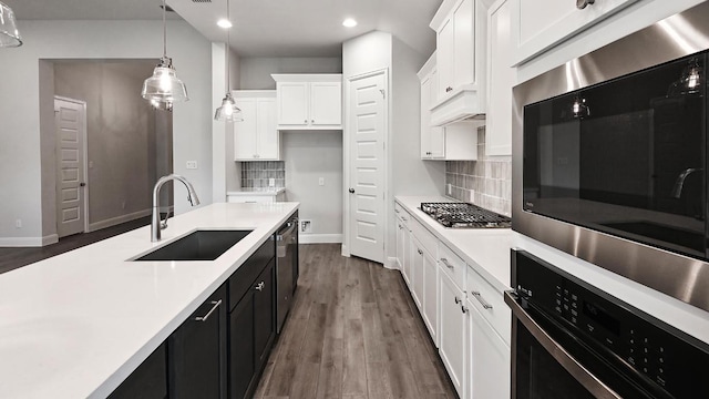 667 Bay Breeze Dr, Kyle, TX 78640 - kitchen featuring recessed lighting, light countertops, white cabinetry, hanging light fixtures, and decorative backsplash