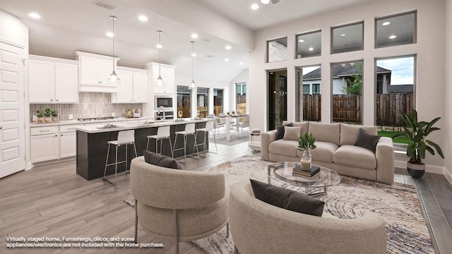667 Bay Breeze Dr, Kyle, TX 78640 - living room with light wood-style flooring, recessed lighting, and a towering ceiling