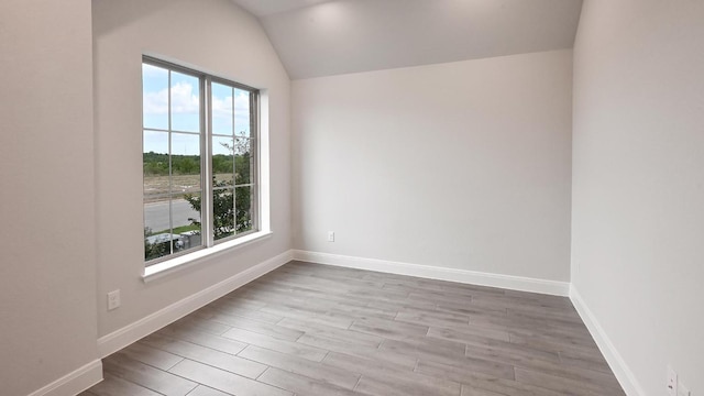 667 Bay Breeze Dr, Kyle, TX 78640 - empty room featuring wood finished floors and vaulted ceiling