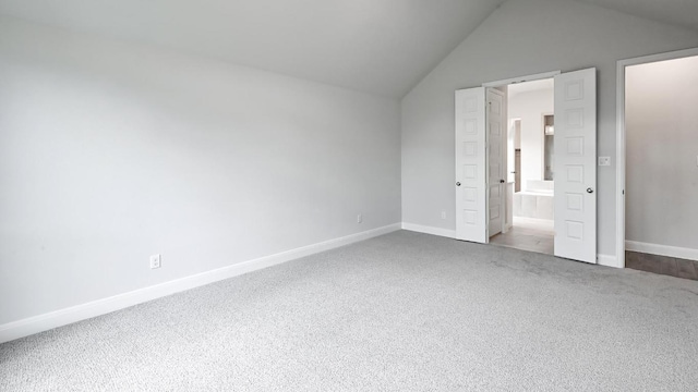 667 Bay Breeze Dr, Kyle, TX 78640 - unfurnished bedroom with carpet, vaulted ceiling, and ensuite bathroom