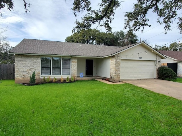 single story home featuring a garage and a front lawn