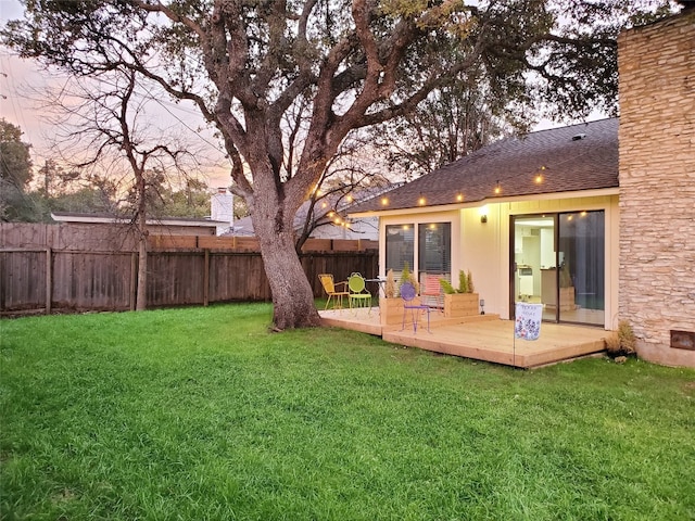 yard at dusk with a wooden deck