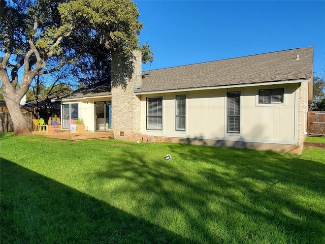 back of property with a patio area, fence, a lawn, and a chimney