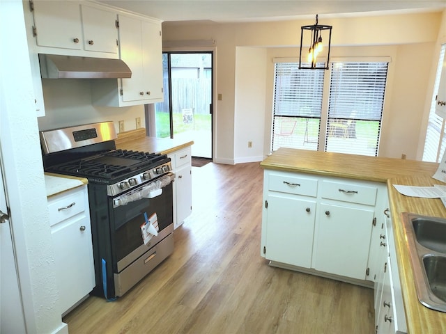 kitchen with gas stove, decorative light fixtures, light hardwood / wood-style flooring, a notable chandelier, and white cabinets