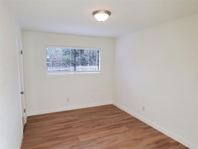 unfurnished room featuring dark hardwood / wood-style flooring