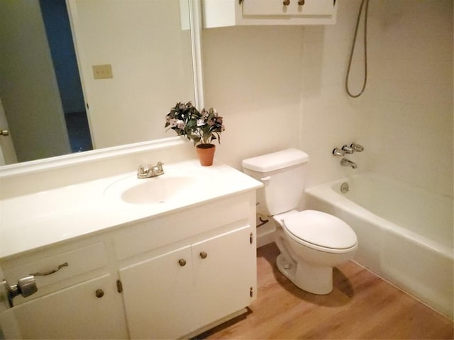 full bathroom featuring hardwood / wood-style flooring, vanity, toilet, and tub / shower combination