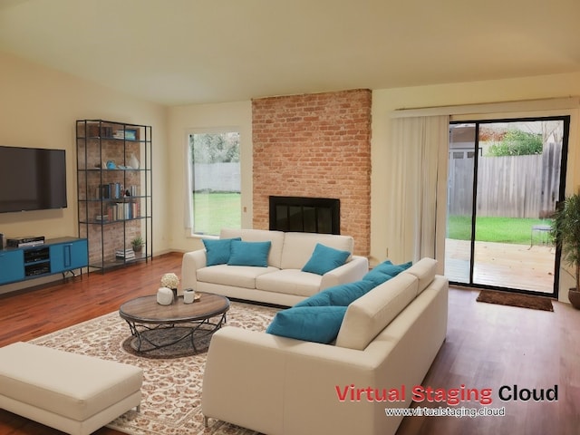 living room with wood-type flooring and a fireplace