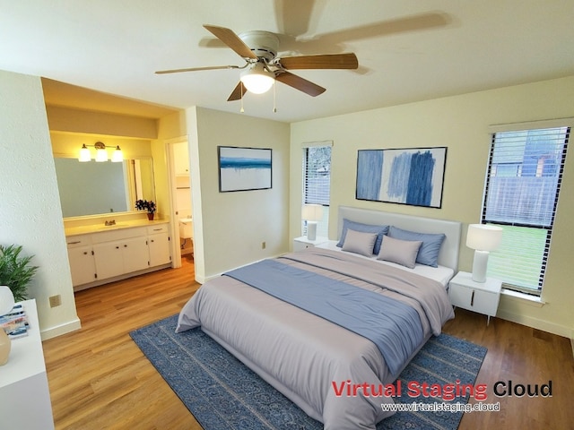 bedroom with connected bathroom, light hardwood / wood-style floors, and ceiling fan