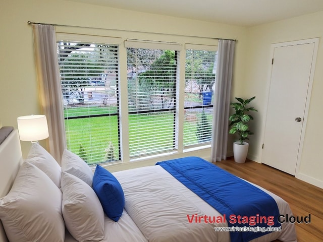 bedroom featuring hardwood / wood-style floors and multiple windows