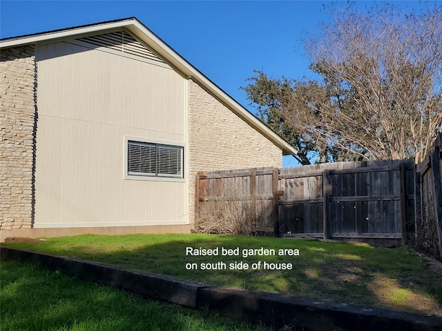 view of property exterior featuring fence and a lawn