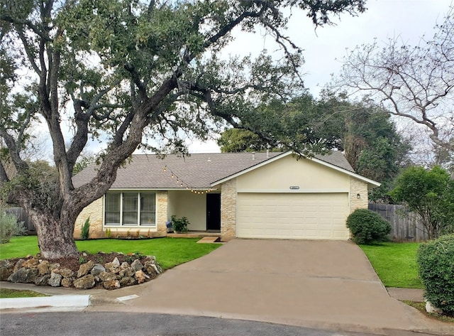 single story home with a garage and a front lawn