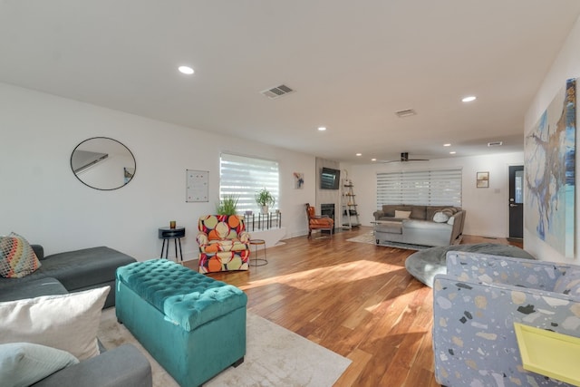 living room featuring ceiling fan and light hardwood / wood-style floors