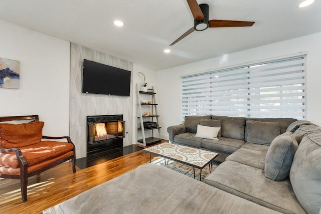 living room with hardwood / wood-style floors, a fireplace, and ceiling fan