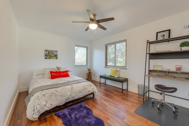 bedroom with ceiling fan and wood-type flooring