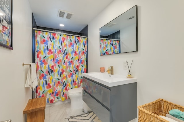 bathroom with vanity, toilet, and walk in shower