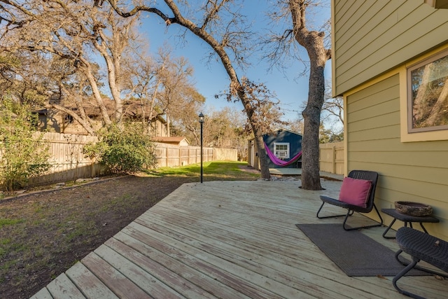 wooden terrace featuring an outbuilding