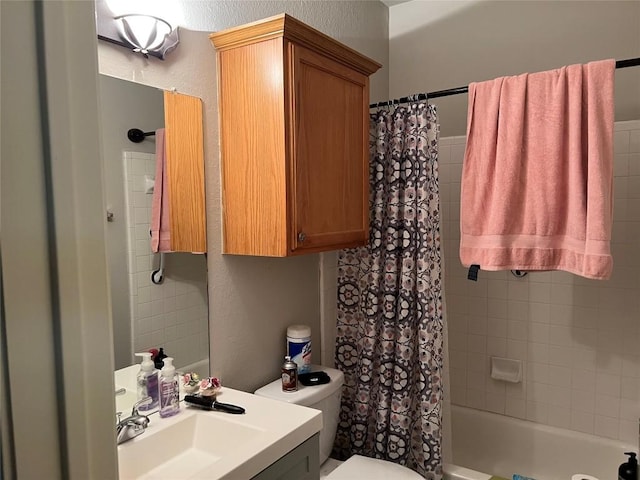 full bathroom featuring vanity, toilet, and shower / tub combo