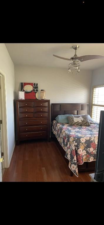 bedroom featuring dark wood-type flooring and ceiling fan