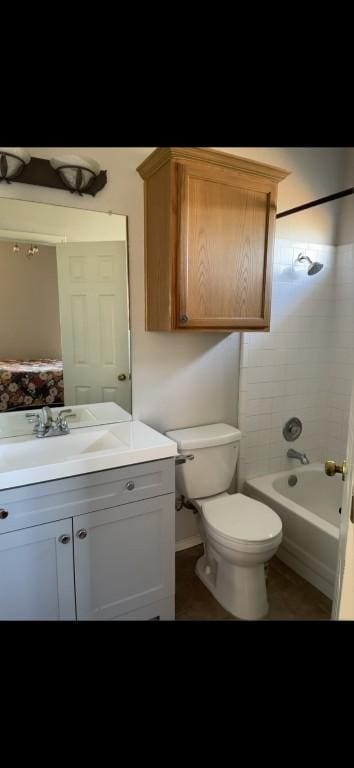 full bathroom with vanity, tiled shower / bath combo, and toilet