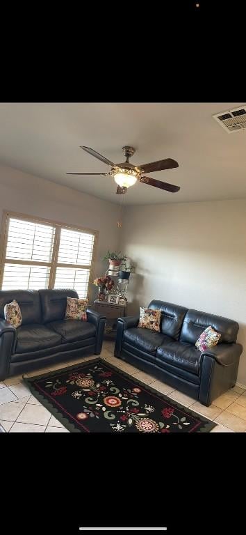 living room featuring light tile patterned flooring and ceiling fan