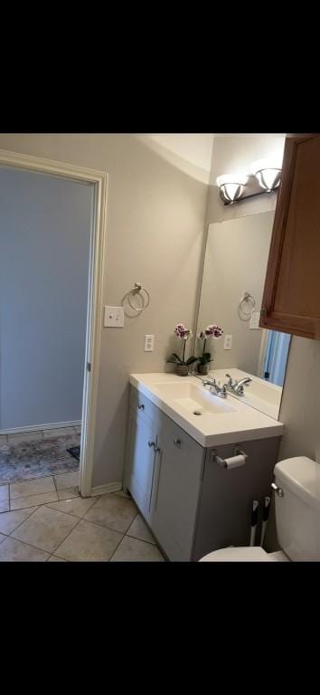 bathroom featuring vanity, tile patterned floors, and toilet