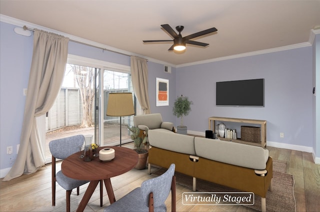 living room featuring ceiling fan, ornamental molding, and light wood-type flooring