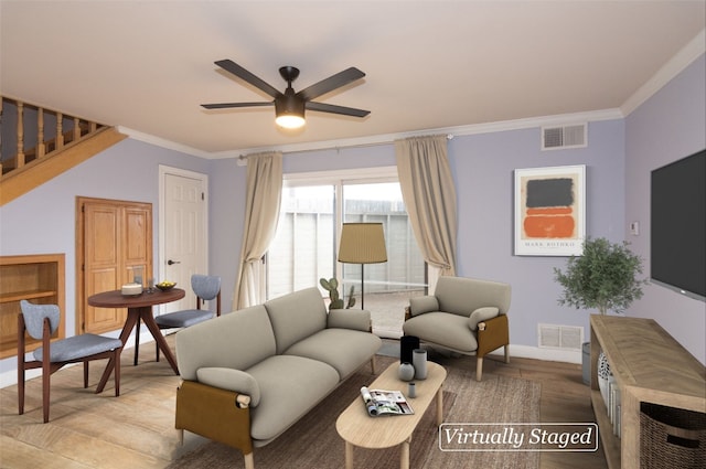 living room with crown molding and ceiling fan