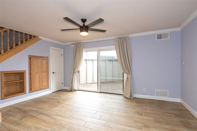 empty room with light wood-style floors, visible vents, a ceiling fan, and baseboards