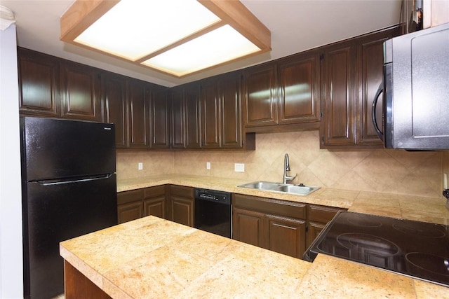 kitchen with dark brown cabinets, sink, and black appliances