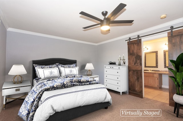 bedroom featuring crown molding, connected bathroom, a barn door, and carpet floors