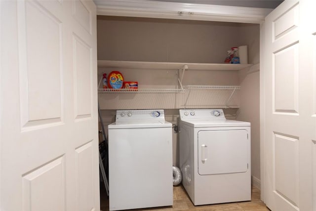 laundry area with light wood finished floors, laundry area, and independent washer and dryer