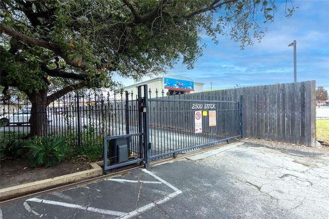 view of gate featuring fence