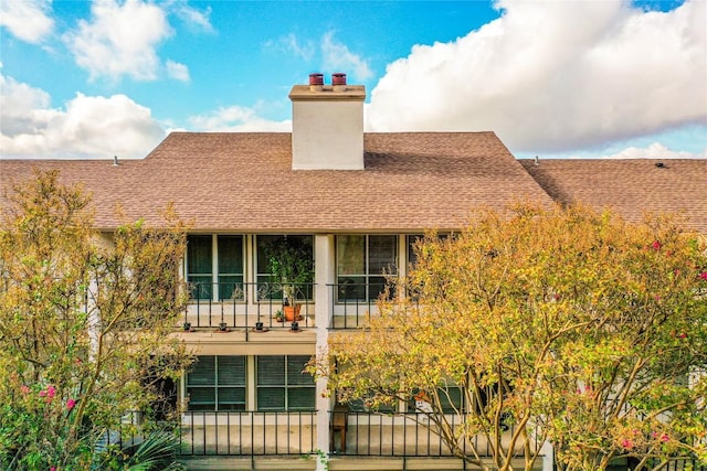 back of house with a balcony