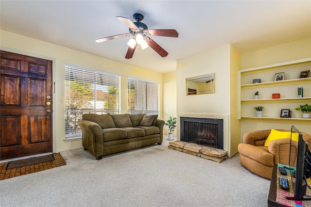 living room with ceiling fan and carpet