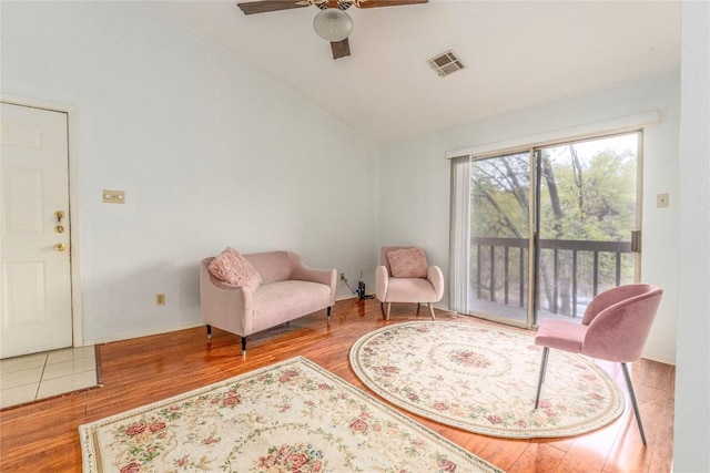 sitting room with ceiling fan, vaulted ceiling, and wood-type flooring