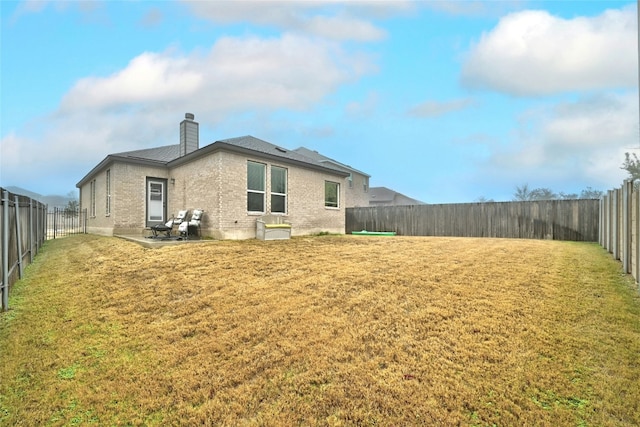 back of house featuring a yard and a patio