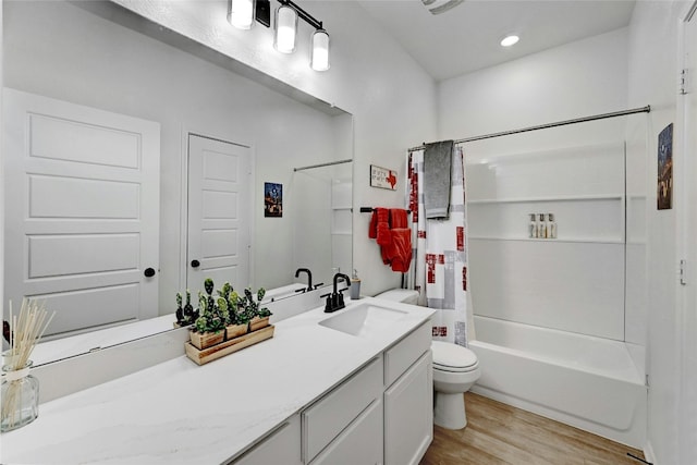 full bathroom featuring shower / tub combo with curtain, vanity, toilet, and hardwood / wood-style floors