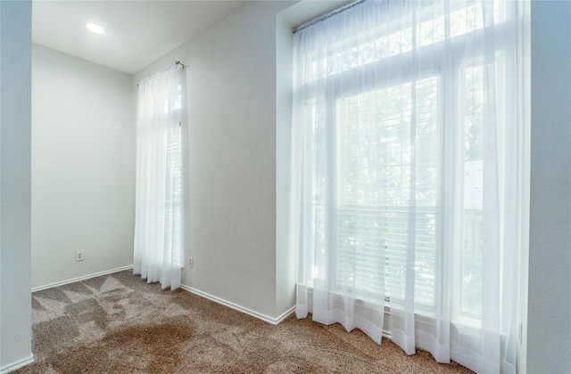 carpeted empty room with plenty of natural light