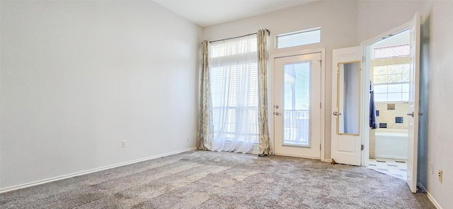 carpeted spare room featuring a healthy amount of sunlight