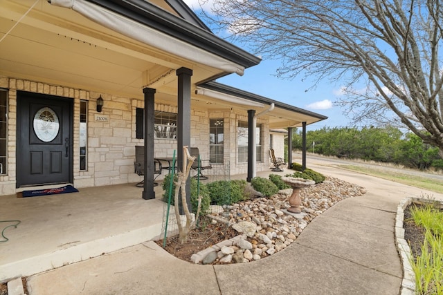 view of exterior entry with covered porch