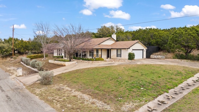 ranch-style home with a garage and a front lawn