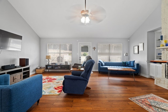 living room featuring vaulted ceiling, dark hardwood / wood-style floors, and ceiling fan